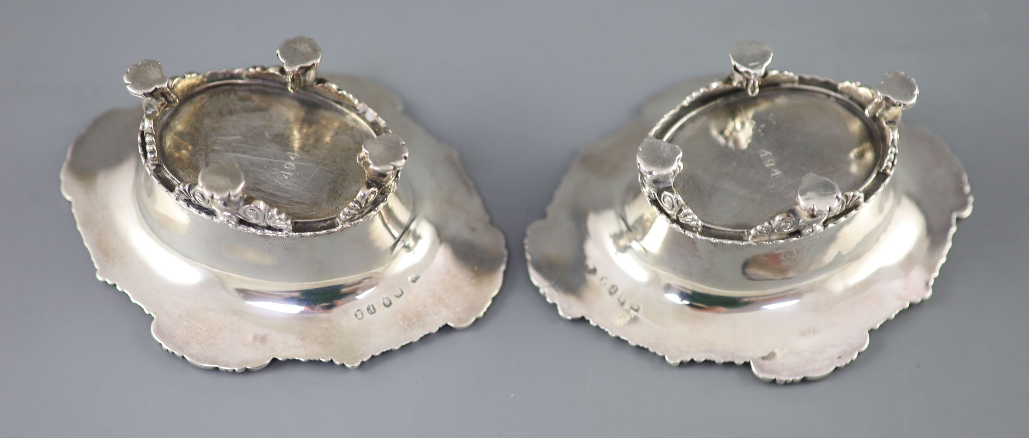 A pair of George III cast silver oval table salts by Paul Storr,